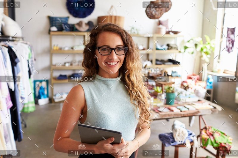 demo-attachment-186-female-business-owner-holding-tablet-computer-in-PEVERD4